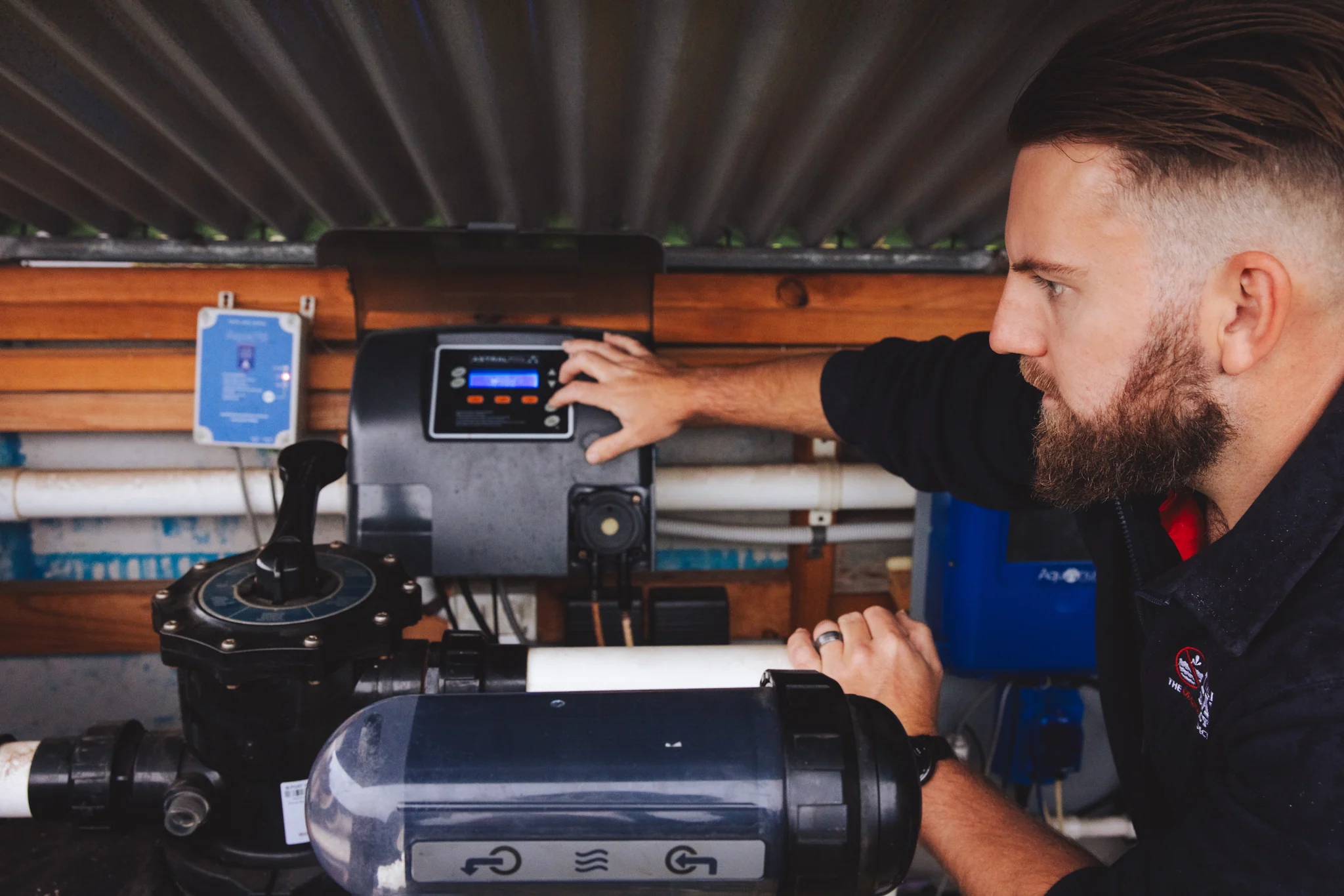 ALD specialist inspecting pool filtration and pressure testing equipment