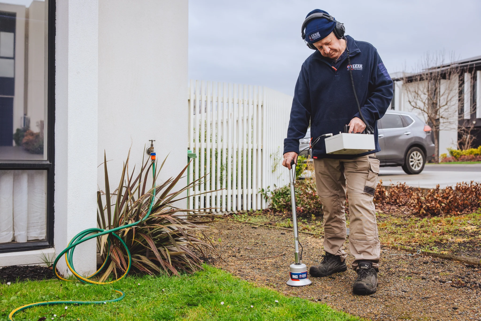 ALD technician using an acoustic ground sensor to locate a leak